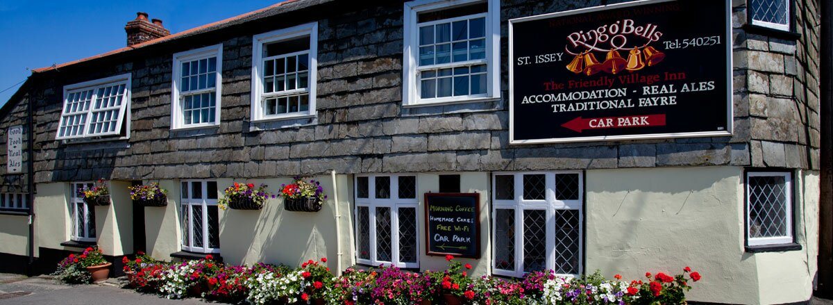 The Ring o&rsquo; Bells frontage with its painted sign reading Ring o&rsquo; Bells, St Issey, The Friendly Village Inn